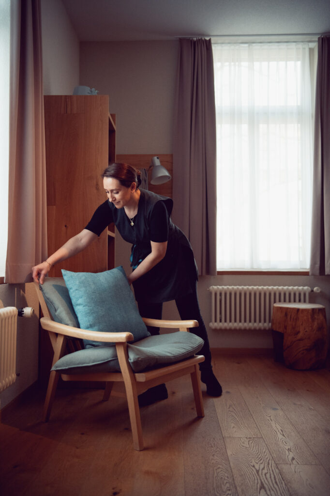 Corporate Branding Aufnahme einer Mitarbeiterin beim Herrichten eines Hotelzimmers für das Hotel Alpenblick in Bern.